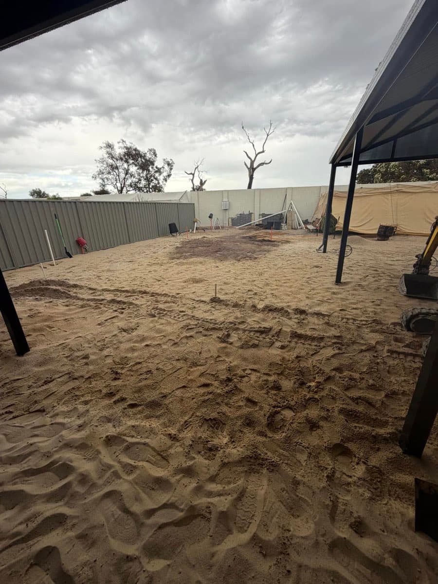 Untouched sandy backyard before excavation