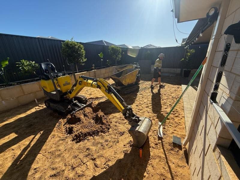 Backyard with mini-excavator and dumper set up